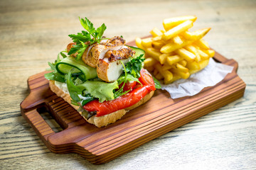 Grilled chicken breast on a toast with tomatoes