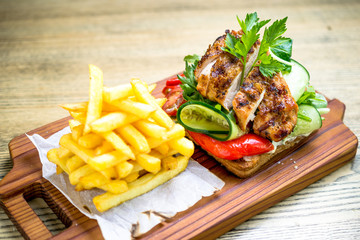 Grilled chicken breast on a toast with tomatoes