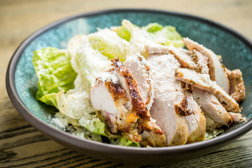 Caesar salad with grilled chicken breast, green