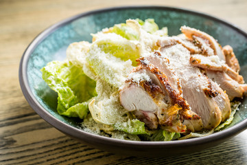 Caesar salad with grilled chicken breast, green