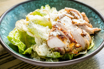 Caesar salad with grilled chicken breast, green