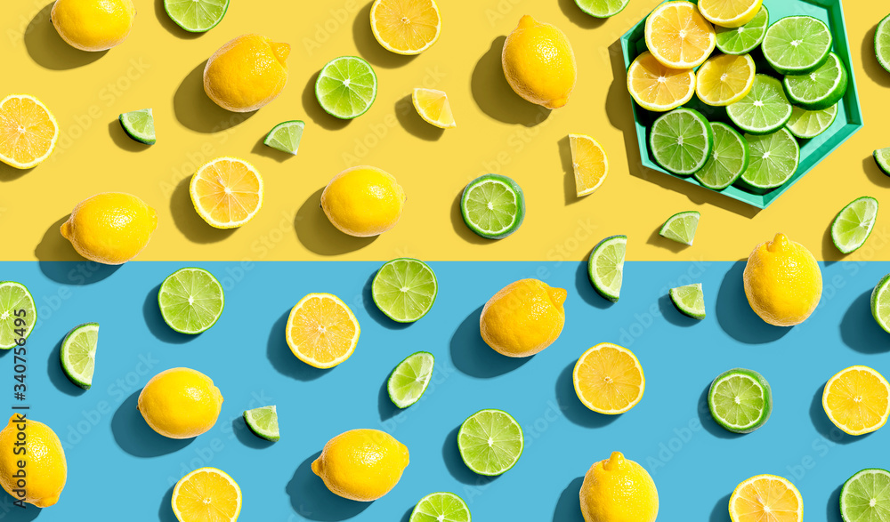 Wall mural Fresh lemons and limes overhead view - flat lay