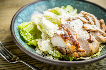 Caesar salad with grilled chicken breast, green