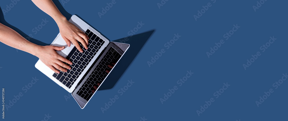 Poster person using a laptop computer from above