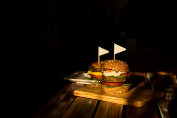 Two hamburgers on a dark background. advertising design for fast food restaurant