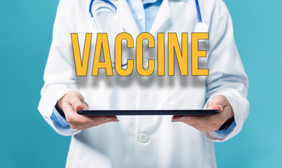 Vaccine theme with a doctor using a tablet computer