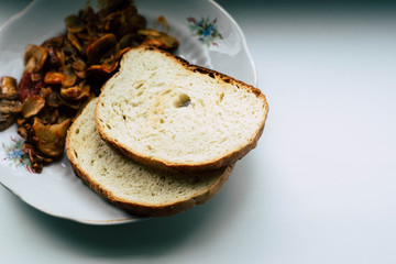 Mushrooms and bread in a white plate