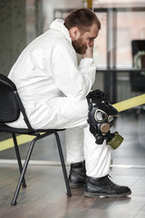 Coronavirus pandemic. Tired, stressed and exhausted doctoror or desinfector specialist after long...