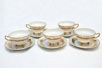 Mock up / design set of elegant and traditional teapot colorful white blue gold coffee cup & Tea cup on cup's plate beside the hot tea pot , design/ drink-ware isolated on white background