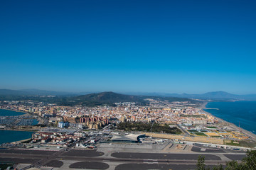 Fototapeta na wymiar Gibraltar, United Kingdom, February 20, 2020:-The town of Gibraltar viewed from up the Rock. Gibraltar is a British Overseas Territory located on the southern tip of Spain.