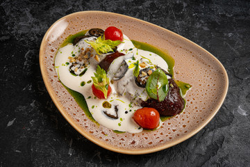 Eggplant grilled with rice and cheese on a black plate. Top view. Rustic style.