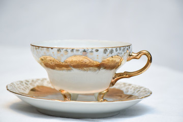 Mock up / design set of elegant and traditional teapot colorful white blue gold coffee cup & Tea cup on cup's plate beside the hot tea pot , design/ drink-ware isolated on white background