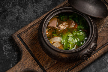 Eggplant grilled with rice and cheese on a black plate. Top view. Rustic style.