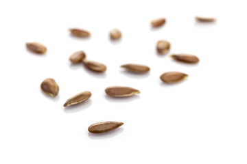 Grains flax organic seeds isolated on white. Pile healthy linseed or flaxseed background. Clean-eating food with antioxidant, omega-3, protein and copy space.