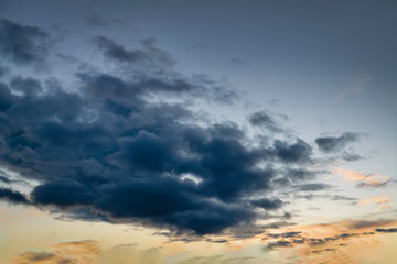 The sky at sunset. Cumulus clouds lit by the rays of the setting sun.