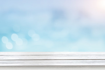 Abstract blue pastel background with wooden base and defocused lights. Empty mockup, blurred backdrop with bokeh