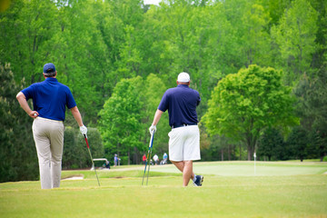 Golfers ready to tee off waiting for other golfers