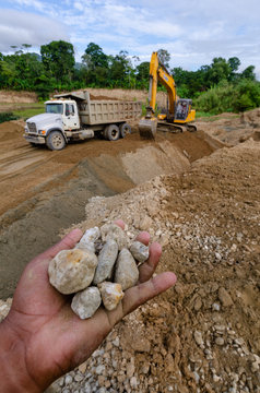 Hands With Stones In A Concrete Aggregate Mine