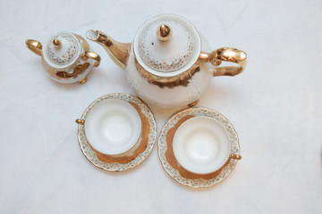 Mock up / design set of elegant and traditional teapot colorful white blue gold coffee cup & Tea cup on cup's plate beside the hot tea pot , design/ drink-ware isolated on white background