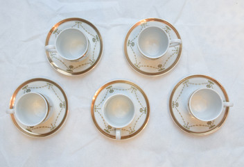 Mock up / design set of elegant and traditional teapot colorful white blue gold coffee cup & Tea cup on cup's plate beside the hot tea pot , design/ drink-ware isolated on white background