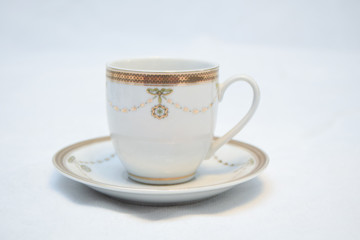 Mock up / design set of elegant and traditional teapot colorful white blue gold coffee cup & Tea cup on cup's plate beside the hot tea pot , design/ drink-ware isolated on white background