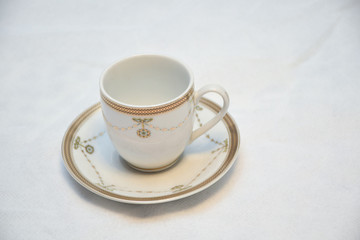 Mock up / design set of elegant and traditional teapot colorful white blue gold coffee cup & Tea cup on cup's plate beside the hot tea pot , design/ drink-ware isolated on white background