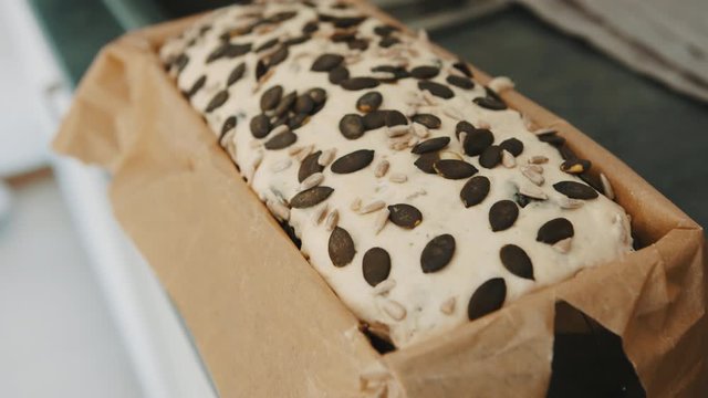 Homemade bread with pumpking seed on the kitchen counter. Close up slow motion shot