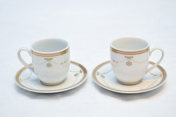 Mock up / design set of elegant and traditional teapot colorful white blue gold coffee cup & Tea cup on cup's plate beside the hot tea pot , design/ drink-ware isolated on white background