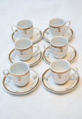 Mock up / design set of elegant and traditional teapot colorful white blue gold coffee cup & Tea cup on cup's plate beside the hot tea pot , design/ drink-ware isolated on white background