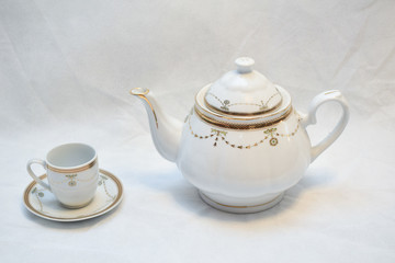 Mock up / design set of elegant and traditional teapot colorful white blue gold coffee cup & Tea cup on cup's plate beside the hot tea pot , design/ drink-ware isolated on white background