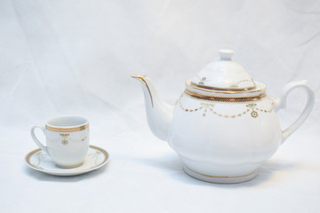 Mock up / design set of elegant and traditional teapot colorful white blue gold coffee cup & Tea cup on cup's plate beside the hot tea pot , design/ drink-ware isolated on white background