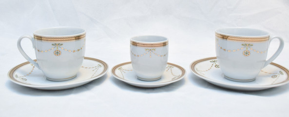 Mock up / design set of elegant and traditional teapot colorful white blue gold coffee cup & Tea cup on cup's plate beside the hot tea pot , design/ drink-ware isolated on white background