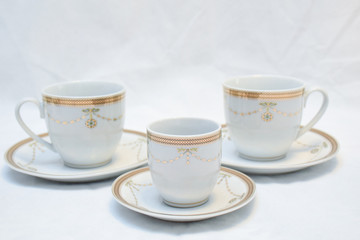 Mock up / design set of elegant and traditional teapot colorful white blue gold coffee cup & Tea cup on cup's plate beside the hot tea pot , design/ drink-ware isolated on white background
