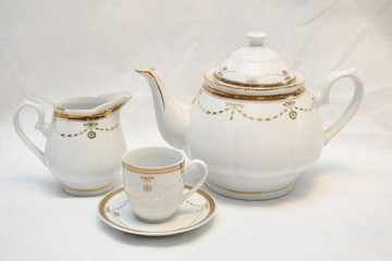 Mock up / design set of elegant and traditional teapot colorful white blue gold coffee cup & Tea cup on cup's plate beside the hot tea pot , design/ drink-ware isolated on white background