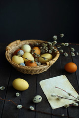 yellow and brown Easter eggs in a basket on a wooden background