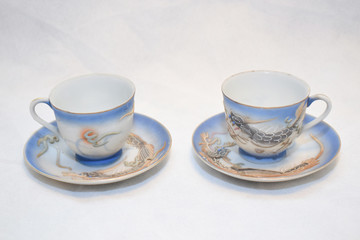 Mock up / design set of elegant and traditional teapot colorful white blue gold coffee cup & Tea cup on cup's plate beside the hot tea pot , design/ drink-ware isolated on white background