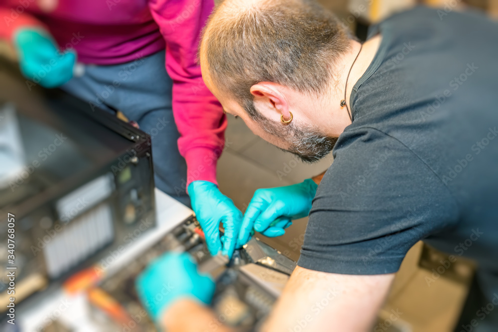 Poster personal computer technicians mounting ssd drive on the motherboard socket, pc assembling