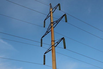 high voltage power lines on blue sky