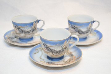Mock up / design set of elegant and traditional teapot colorful white blue gold coffee cup & Tea cup on cup's plate beside the hot tea pot , design/ drink-ware isolated on white background