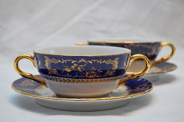 Mock up / design set of elegant and traditional teapot colorful white blue gold coffee cup & Tea cup on cup's plate beside the hot tea pot , design/ drink-ware isolated on white background