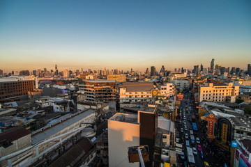 Fototapeta premium Bangkok, Thailand - February 2020: Above view from rooftop on China town in the middle of city Bangkok, Thailand