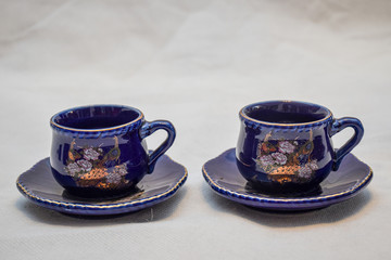 Mock up / design set of elegant and traditional teapot colorful white blue gold coffee cup & Tea cup on cup's plate beside the hot tea pot , design/ drink-ware isolated on white background