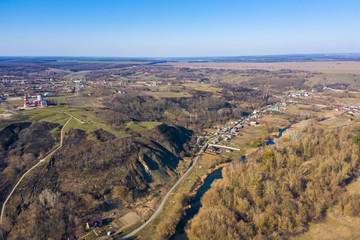 view from the drone to the hills, village with a Church on top, spring Sunny day, Central Russia