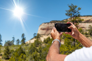 Tourist photographing natural landscape with the smartphone. Holiday and vacation concept