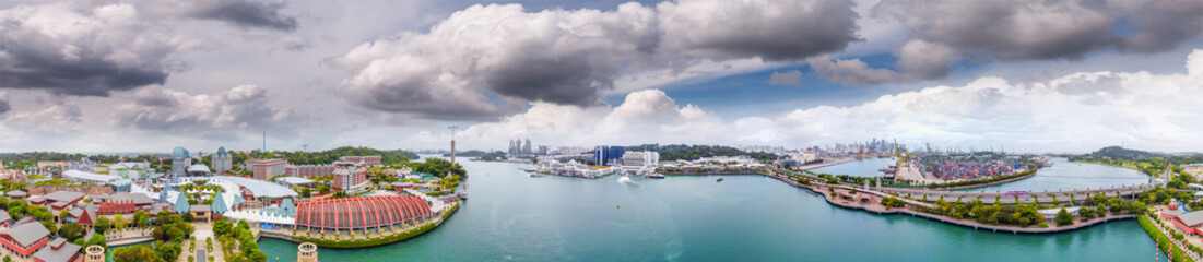 Fototapeta premium Sentosa Island, Singapore. Panoramic aerial view of cityscape and coastline at sunset