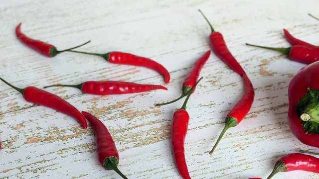 Fresh Raw Red Chili Peppers And Ramiro Pepper On A Wooden Background Panning Slider Shot. Natural Daylight..