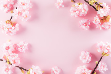 Fototapeta na wymiar Happy Mother's Day, Women's Day or Valentine's Day greeting concept. Pastel Pink Colours Background with blossom flowers flat lay patterns.