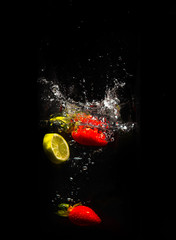 Fototapeta na wymiar Fruits splashing in the water