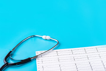 Stethoscope and cardiogram on a blue background. Close-up. Copy-space. The place to insert the text.