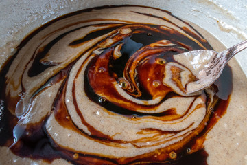 mixing gingerbread ingredients with molasses in large mixing bowl